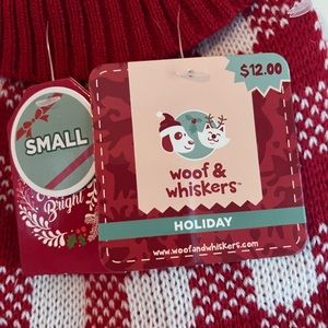 New red and white dog sweater size small. Does not fit my pug (20 lbs).